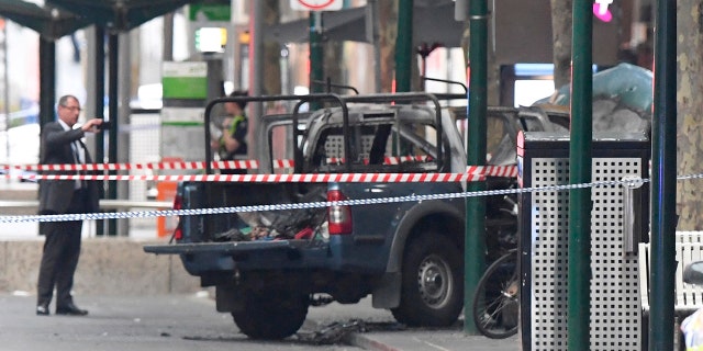 A burnt out vehicle is seen on Bourke Street in Melbourne, Friday, Nov. 9, 2018.