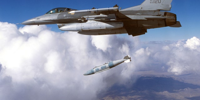 File photo - A Block 30 F-16 from the 416th Flight Test Squadron drops a Joint Direct Attack Munition (JDAM) during testing in January, 2003 at Edwards Air Force Base in California. (Photo by Tom Reynolds/U.S. Air Force/Getty Images)