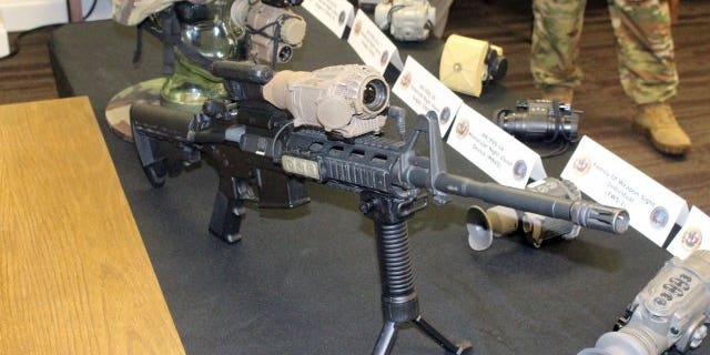 File photo - An Enhanced Night Vision Goggle III is mounted on a glass skull, and a Family of Weapons Sights-Individual is mounted on an M4 rifle, at Fort Belvoir, Va. The ENVG III, worn on the head, can be paired wirelessly with a FWS-I, which would be mounted on a weapon, to allow soldiers to see in their eye what the weapon sight is seeing. (Photo Credit: Jalen Brown)