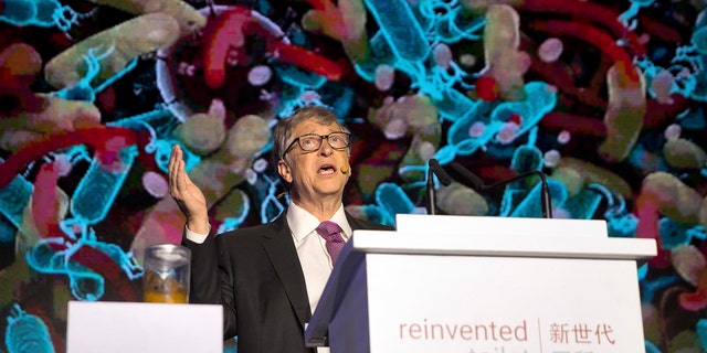 Bill Gates, former Microsoft CEO and co-founder of the Bill and Melinda Gates Foundation, speaks as a jar of human feces sits on a podium at the Reinvented Toilet Expo in Beijing, Tuesday, Nov. 6, 2018.