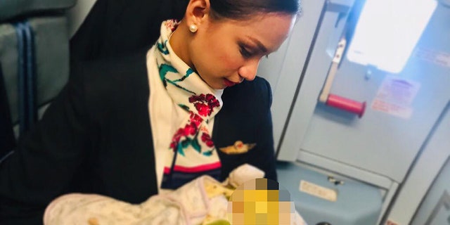 Patrisha Organo, 24, breastfeeding a stranger's child during a flight.