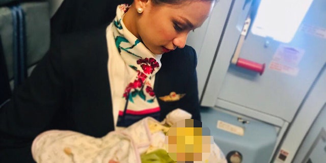Patrisha Organo, 24, breastfeeding a strangers child during a flight.