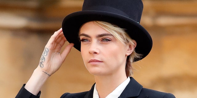 Cara Delevingne attended Princess Eugenie's royal wedding a suit and top hat.