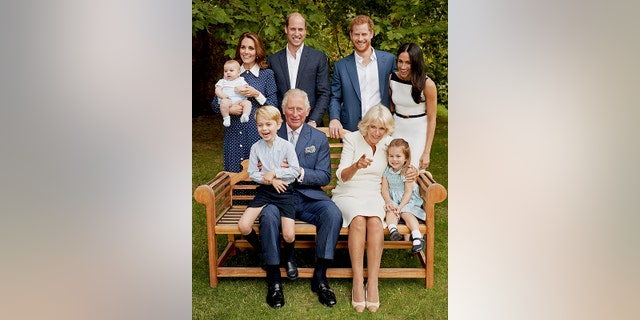 In this handout image provided by Clarence House and taken on Sept. 5, 2018, Britain's Prince Charles poses for an official portrait to mark his 70th Birthday in the gardens of Clarence House, with Camilla, Duchess of Cornwall, Prince William, Kate, Duchess of Cambridge, Prince George, Princess Charlotte, Prince Louis, Prince Harry and Meghan, Duchess of Sussex, in London, England. (Chris Jackson/Pool Photo)