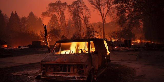 Flames burn inside a van as the Camp Fire tears through Paradise, Calif., on Thursday, Nov. 8, 2018. (AP Photo/Noah Berger, File)