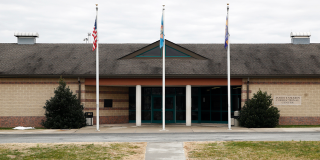 FILE - This Dec. 22, 2017, file photo shows the front entrance of the James T. Vaughn Correctional Center in Smyrna, Del. Delaware taxpayers have shelled out more than $360,000 in legal defense costs for 18 prisoners charged in a deadly prison riot last year - and the bills will continue to pile up as the trials get under way. (AP Photo/Patrick Semansky, File)