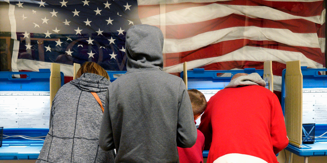 FILE- In this Nov. 2, 2018, file photo residents vote early at the Douglas County Election Commission office in Omaha, Neb. For voters across America, this year's midterm elections represent something far greater than whatever Senate and House races appear on their ballots. It is a referendum on President Donald Trump and the venomous political culture that many blame for gridlock in Congress and a recent spate of hate crimes and politically motivated attacks. (AP Photo/Nati Harnik, File)