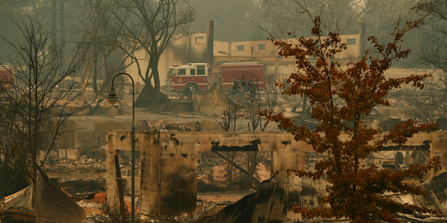 A fire truck drives through an area burned in the wildfire, Tuesday, Nov. 13, 2018, in Paradise, Calif. Five days after flames all but obliterated the Northern California town, officials were unsure of the exact number of missing. But the death toll was almost certain to rise. (AP Photo/John Locher)