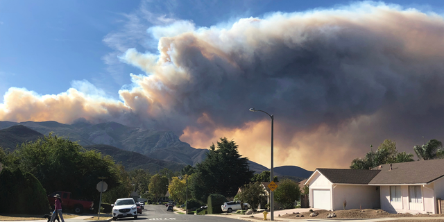 A large wildfire plume from a recent flareup near Lake Sherwood, Calif., is visible from Thousand Oaks, Calif., Tuesday, Nov. 13, 2018. (AP Photo/Amanda Myers)