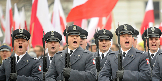 Polish Army soldiers salute during the official ceremony marking Poland's Independence Day, in Warsaw, Poland, Sunday, Nov. 11, 2018. The Independence Day in Poland celebrates the nation regaining its sovereignty at the end of World War I after being wiped off the map for more than a century. (AP Photo/Alik Keplicz)