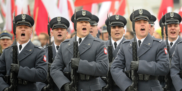 Polish Army soldiers salute during the official ceremony marking Poland's Independence Day, in Warsaw, Poland, Sunday, Nov. 11, 2018. The Independence Day in Poland celebrates the nation regaining its sovereignty at the end of World War I after being wiped off the map for more than a century. (AP Photo/Alik Keplicz)