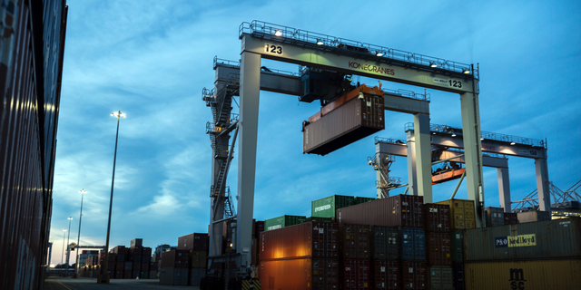 FILE- In this July 5, 2018, file photo, a rubber tire gantry moves a shipping container in the container yard at the Port of Savannah in Savannah, Ga. On Friday, Nov. 2, the Commerce Department reports on the U.S. trade gap for September. (AP Photo/Stephen B. Morton, File)