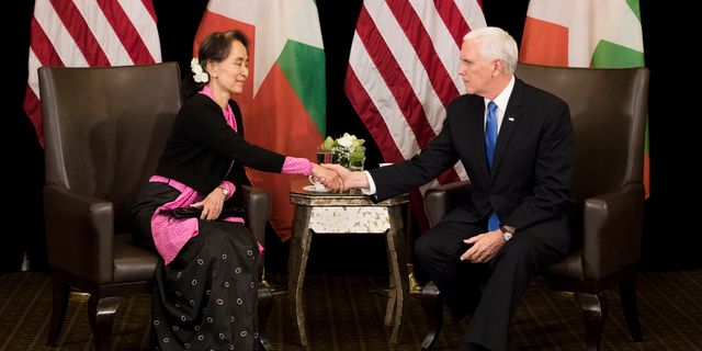 U.S. Vice President Mike Pence, right, meets Myanmar leader Aung San Suu Kyi in Singapore, Wednesday, Nov. 14, 2018. Pence is Singapore to attend the 33rd ASEAN summit. (AP Photo/Bernat Armangue, Pool)