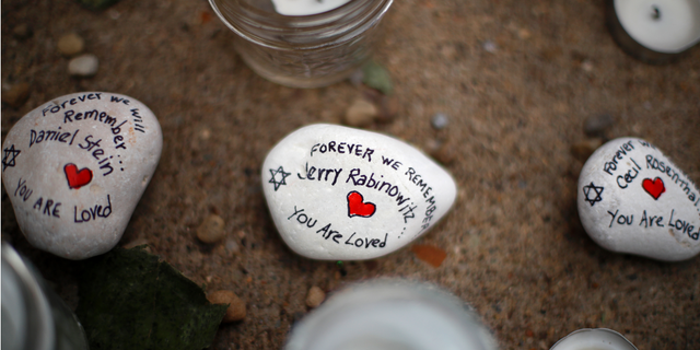 These are stones found on Wednesday, Oct. 31, 2018, part of a makeshift memorial outside the Tree of Life Synagogue to the 11 people killed during worship services Saturday Oct. 27, 2018 in Pittsburgh. (AP Photo/Gene J. Puskar)