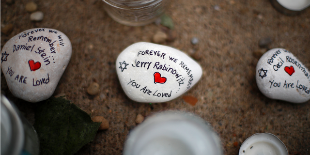 These are stones found on Wednesday, Oct. 31, 2018, part of a makeshift memorial outside the Tree of Life Synagogue to the 11 people killed during worship services Saturday Oct. 27, 2018 in Pittsburgh. (AP Photo/Gene J. Puskar)