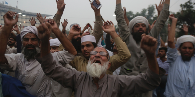 Protesters shout slogans during a rally to condemn a Supreme Court decision that acquitted Asia Bibi, a Christian woman, who spent eight years on death row accused of blasphemy, in Lahore, Pakistan, Friday, Nov. 2, 2018. The release of Bibi was apparently delayed Friday after talks failed between the government and radical Islamists who want her publicly hanged. (AP Photo/K.M. Chaudary)