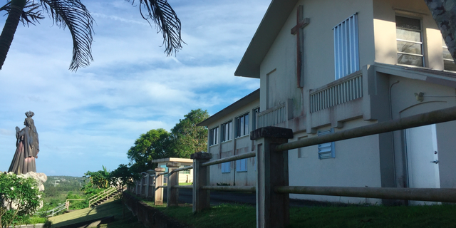 This photo shows the residence and office of the Archbishop of Agana in Guam on Wednesday, Nov. 7, 2018. The house was listed as one of the non-essential properties owned by the Catholic Church in Guam, which announced on Wednesday that it will file for Chapter 11 reorganization bankruptcy to avoid trial in dozens of lawsuits alleging child sexual abuse by priests and move toward settlements. The funds for future victims claims will come from the sale of non-essential church properties and insurance. (AP Photo/Grace Garces Bordallo)