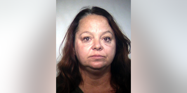 FILE - This March 15, 2018 file booking photo provided by the Tempe, Ariz., Police Department shows Elizabeth Dauenhauer, who was captured on video making derogatory comments about Muslims as she took pamphlets from an Arizona mosque. Dauenhauer, who tore down fliers from bulletin boards and removed fliers from bins in a courtyard behind the mosque in Tempe, is scheduled to be sentenced Thursday, Nov. 8 for her criminal damage conviction. (Tempe Police Department via AP, File)