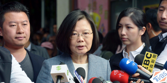 Taiwanese President Tsai Ing-wen, center, speaks to journalists after a vote in local elections in New Taipei City, Taiwan.