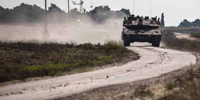 An Israeli tank drives near the Israel Gaza border, Tuesday, Nov. 13, 2018. (AP Photo/Tsafrir Abayov)