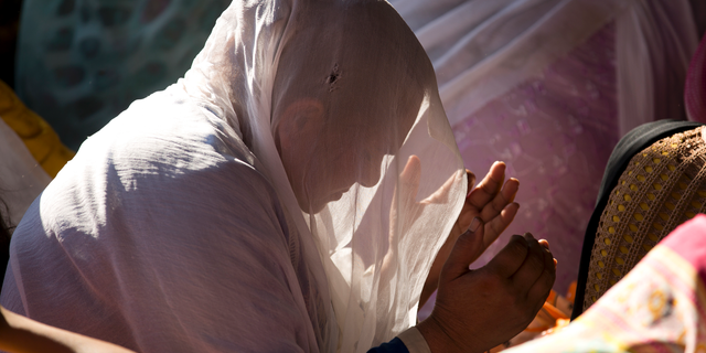 FILE - In this March 30, 2018, file photo, a Pakistani Christian woman prays during a Good Friday service at a church in Islamabad, Pakistan. The uproar surrounding Aasia Bibi _ a Pakistani Christian woman who was acquitted of blasphemy charges and released from death row but remains in isolation for her protection _ has drawn attention to the plight of the country's Christians.The minority, among Pakistan's poorest, has faced an increasingly intolerant atmosphere in this Muslim-majority nation where radical religious and sectarian groups have become more prominent in recent years. (AP Photo/B.K. Bangash, File)