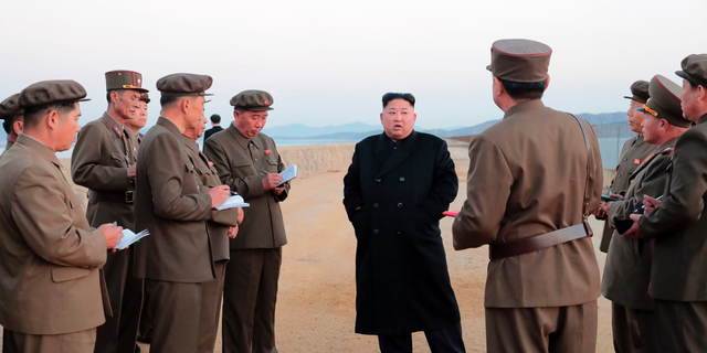 North Korean leader Kim Jong Un, center, listens to a military official as he inspects a weapon testing at the Academy of National Defense Science, North Korea. (Korean Central News Agency/Korea News Service via AP)
