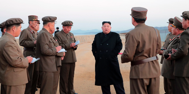 North Korean leader Kim Jong Un, center, listens to a military official as he inspects a weapon testing at the Academy of National Defense Science, North Korea. (Korean Central News Agency/Korea News Service via AP)