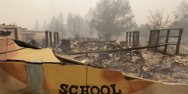 The burned remains of the Paradise Elementary school is seen Friday, Nov. 9, 2018, in Paradise, Calif. Blocks and blocks of homes and businesses in the Northern California town have been destroyed by a wildfire. Parts of the town of Paradise were still on fire on Friday. (AP Photo/Rich Pedroncelli)