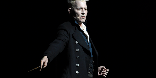 FILE - In this July 21, 2018 file photo, Johnny Depp appears in character as Gellert Grindelwald at the Warner Bros. Theatrical panel for "Fantastic Beasts: The Crimes of Grindelwald" on day three of Comic-Con International in San Diego. Depp's charismatic leader at the center of the new "Fantastic Beasts" sequel isn't modeled on President Donald Trump. But the stars of "Crimes of Grindelwald," which J.K. Rowling was writing during the 2016 U.S. presidential campaign, say there are some similarities. (Photo by Chris Pizzello/Invision/AP, File)