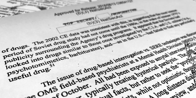 A portion of a once-classified CIA report that disclosed the existence of a drug research program dubbed "Project Medication" is photographed in Washington, Tuesday, Nov. 13, 2018. Shortly after 9/11, the CIA considered using a drug that might work like a truth serum and force terror suspects to give up information about potential attacks. After months of research, the agency decided that a drug called Versed, a sedative often prescribed to reduce anxiety, was “possibly worth a try.” But in the end, the CIA decided not to ask government lawyers to approve its use. The American Civil Liberties Union fought in court to have the report released. (AP Photo/Jon Elswick