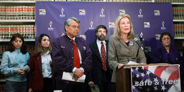 FILE - In this Jan. 17, 2002 file photo, Ramona Ripston, executive director of the American Civil Liberties Union of Southern California, at podium, announces a legal challenge to the recently enacted Aviation and Transportation Security Act, which denies qualified, lawful, permanent residents of the United States the opportunity to continue employment as screeners because they are not at the moment citizens, at the ACLU/SC in Los Angeles. Ripston, a longtime activist who built up the American Civil Liberties Union of Southern California into a major organization, has died at age 91. Ripston died Saturday, Nov. 3, 2018, at her home after several years of illness, said David Colker, a spokesman for the chapter. (AP Photo/Damian Dovarganes, File)