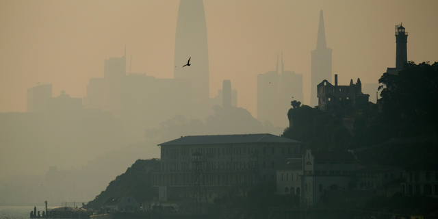 File photo - The San Francisco skyline is obscured by smoke and haze from wildfires behind Alcatraz Island Wednesday, Nov. 14, 2018, in San Francisco.