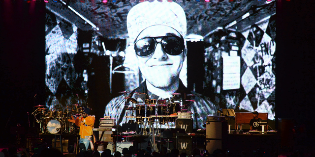 Juicy J performs during the tribute event Mac Miller: A Celebration of Life on Wednesday, Oct. 31, 2018, at the Greek Theatre in Los Angeles. Pictured on screen is the late rapper Mac Miller. (Photo by Amy Harris/Invision/AP)