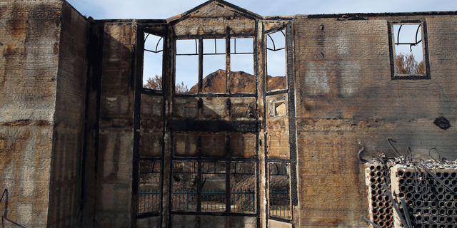 The charred window frames of a mansion destroyed by the Woolsey fire Tuesday, Nov. 13, 2018, in Agoura Hills, Calif.
