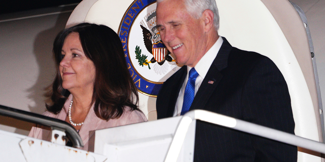U.S. Vice President Mike Pence walks with his wife Karen as they exit Air Force Two upon landing at Yokota Air Base in Fussa on the outskirts of Tokyo Monday, Nov. 12, 2018. Pence has arrived in Tokyo on an overnight visit to discuss North Korea and other issues with Japanese officials before heading to two regional summits. (AP Photo/Eugene Hoshiko)