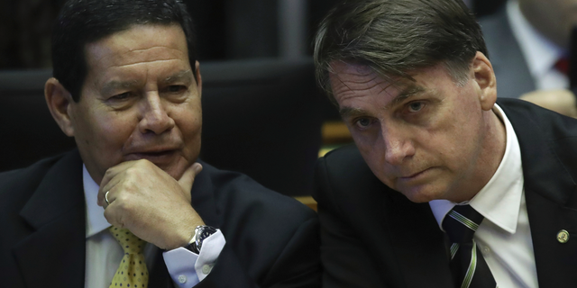 President-elect Jair Bolsonaro, right, and his vice president General Hamilton Mourao, attend a ceremony to celebrate the 30th anniversary of Brazil’s constitution at the National Congress, in Brasilia, Brazil, Tuesday, Nov. 6, 2018. Bolsonaro is insisting on his respect for the country's constitution, implicitly responding to fears his administration might roll back civil rights. (AP Photo/Eraldo Peres)