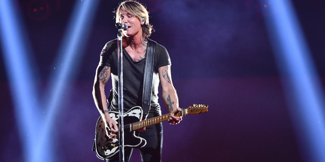 Keith Urban performs "Never Comin' Down" at the 52nd annual CMA Awards at Bridgestone Arena on Wednesday, Nov. 14, 2018, in Nashville, Tenn.