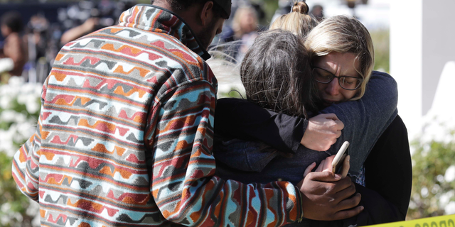 Mourners embrace outside of the Thousand Oaks Teen Center, where relatives and friends gathered in the aftermath of a mass shooting, Thursday, Nov. 8, 2018, in Thousand Oaks, Calif. Multiple people were shot and killed late Wednesday by a gunman who opened fire at the Borderline Bar & Grill, which was holding a weekly country music dance night for college students. (AP Photo/Marcio Jose Sanchez)