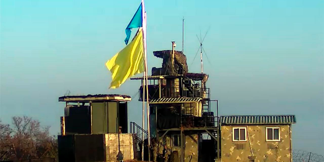 In this Nov. 4, 2018, photo provided by South Korea Defense Ministry, a yellow flag is raised at a guard post of South Korea in the demilitarized zone, South Korea. A South Korean Defense Ministry official said on Saturday, Nov. 10, 2018, the North and South Korean militaries have completed withdrawing troops and firearms from 22 front-line guard posts as they continue to implement a wide-ranging agreement reached in September to reduce tensions. The flag marks the post that is to be dismantled so that each side can observe the work in progress.(South Korea Defense Ministry via AP).
