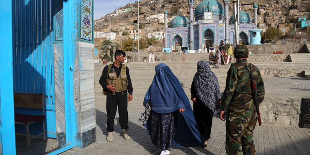 In this Tuesday, Oct. 30, 2018, photo Afghan security guard the gate of the Karti Sakhi shrine in Kabul, Afghanistan. Synagogues, mosques, churches and other houses of worship are routinely at risk of attack in many parts of the world. And so worshippers themselves often feel the need for visible, tangible protection even as they seek the divine. (AP Photo/Rahmat Gul)