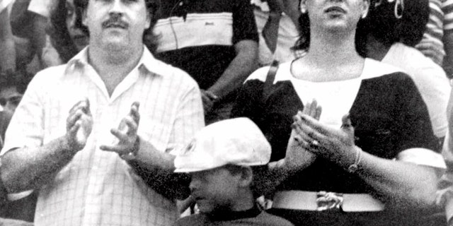 FILE - In this undated file photo, the late Pablo Escobar, former boss of the Medellin drug cartel, his wife Maria Henao and their son Juan Pablo, attend a soccer match in Bogota, Colombia. The widow of Pablo Escobar fell madly in love as a preteen with the man who would rise to be a ruthless drug lord, but says in a new book she felt raped when at age 14 he forced her to have an abortion, and over time came to view him as a cruel psychopath. (El Tiempo Photo via AP File)