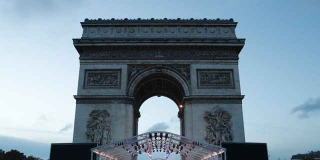 A stand is set up in front the Arc de Triomphe ahead of ceremonies marking the 100th of the end of World War I, Friday, Nov.9, 2018. About 60 leaders will mark Sunday the cease-fire that came on the 11th hour of the 11th day of the 11th month of 1918. (AP Photo/Thibault Camus)