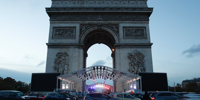 A stand is set up in front the Arc de Triomphe ahead of ceremonies marking the 100th of the end of World War I, Friday, Nov.9, 2018. About 60 leaders will mark Sunday the cease-fire that came on the 11th hour of the 11th day of the 11th month of 1918. (AP Photo/Thibault Camus)