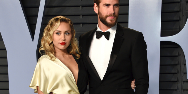 Miley Cyrus, left, and Liam Hemsworth arrive at the Vanity Fair Oscar Party in Beverly Hills, Calif. Though Cyrus and Hemsworth lost their home in the deadly wildfire blazing California, they are donating $500,000 to The Malibu Foundation through Cyrus’ charity, The Happy Hippie Foundation.