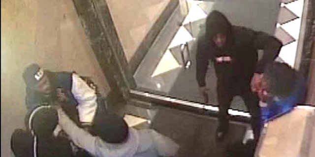 This April 3, 2018 still image from a surveillance video, provided by the U.S. Attorney's Office, Southern District of New York, was released by federal prosecutors to document alleged involvement by rapper Tekashi 6ix9ine in several violent incidents and to support their request to a judge that the rapper be denied bail. Authorities say this frame shows 6ix9nine — whose legal name is Daniel Hernandez — carrying a firearm into a building near Times Square where Hernandez and others participated in a gunpoint robbery of a rival. (U.S. Attorney's Office via AP)