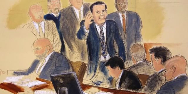Joaquin "El Chapo" Guzman, surrounded by US Marshals, waves to his wife as he enters the courtroom at Brooklyn Federal Court, as his high-security trial got underway in the Brooklyn borough of New York, Tuesday, Nov. 13, 2018. The infamous Mexican drug lord has been held in solitary confinement since his extradition to the United States early last year. Guzman pleaded not guilty to charges that he amassed a multi-billion-dollar fortune smuggling tons of cocaine and other drugs in a vast supply chain that reached New York, New Jersey, Texas and elsewhere north of the border. (Elizabeth Williams via AP)