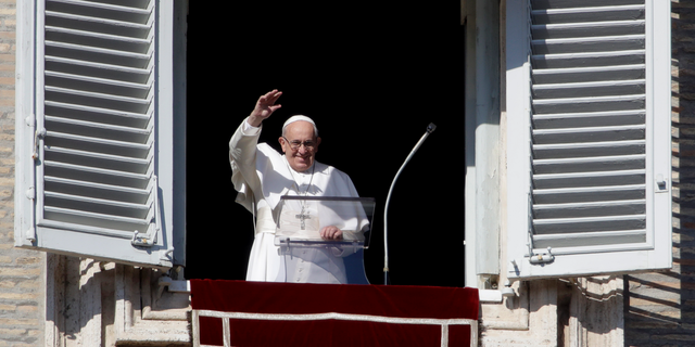 Pope Francis waves as he arrives to recite the Angelus noon prayer from the window of his studio overlooking St.Peter's Square, at the Vatican, Sunday, Nov. 11, 2018. (AP Photo/Alessandra Tarantino)