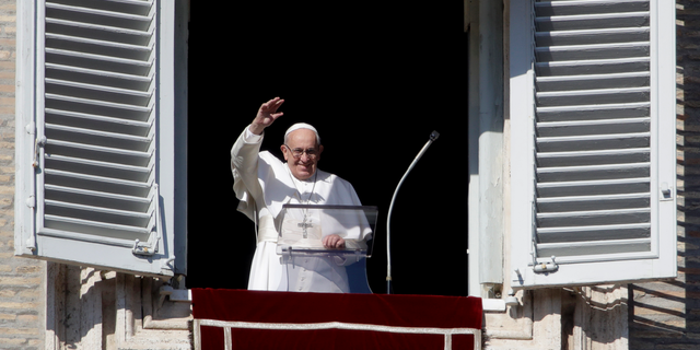 Pope Francis waves as he arrives to recite the Angelus noon prayer from the window of his studio overlooking St.Peter's Square, at the Vatican, Sunday, Nov. 11, 2018. (AP Photo/Alessandra Tarantino)