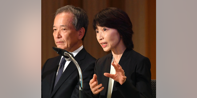 Tokyo Medical University President Yukiko Hayashi, right, speaks during a press conference in Tokyo, Wednesday, Nov. 7, 2018.  The Japanese medical university that has acknowledged systematically discriminating against female applicants has announced plans to accept more than 60 who had been unfairly rejected in the past two years.  The discriminatory policy at Tokyo Medical University surfaced earlier this year, triggering national outrage. The school acknowledged in August that it has been slashing female applicants' entrance exam scores for years to keep the female student population low, saying women tend to quit as doctors after starting families.(Kyodo News via AP)