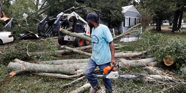 The sound of chainsaws grind through a neighborhood in Natchez, Miss., as cleanup begins following a tornado that hit early Thursday, Nov. 1, 2018. At least 11 tornadoes have been confirmed by National Weather Service surveyors so far in Louisiana and Mississippi as part of a storm system that moved across the region Wednesday night and Thursday. (AP Photo/Rogelio V. Solis)
